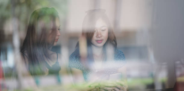 istock Two beautiful asian women talking together while spending their time at the mall 1177165205