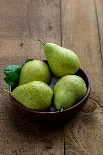 Istanbul, Turkey-August 18, 2022: Four asian pears on a dark green background. Shot with Canon EOS R5.
