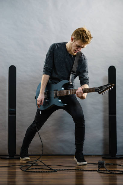 istock Young man playing electric guitar 1177166520
