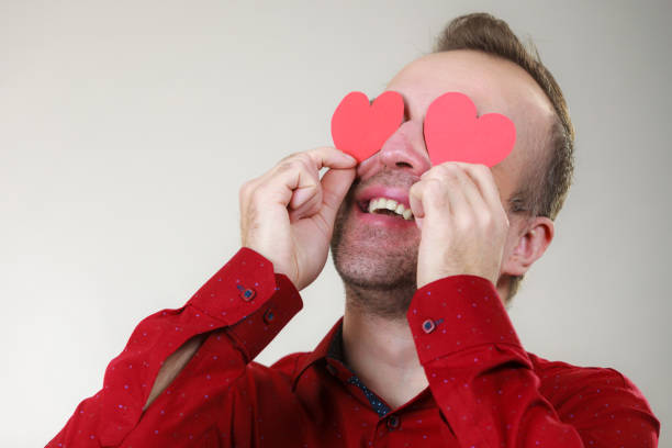 istock Man in love with hearts on eyes 1177166561