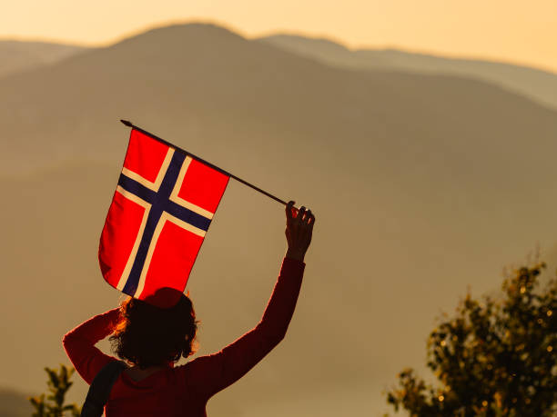 istock Tourist with norwegian flag and mountains landscape 1177167759