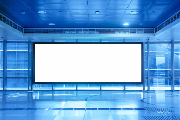 Advertisement mockup. Blank empty billboard inside a shopping mall or metro underground in Dubai, UAE. Blue toned
