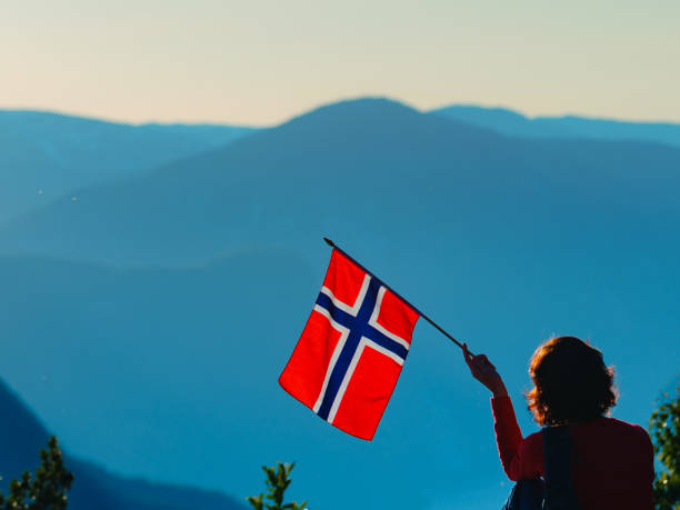istock Tourist with norwegian flag and mountains landscape 1177169622