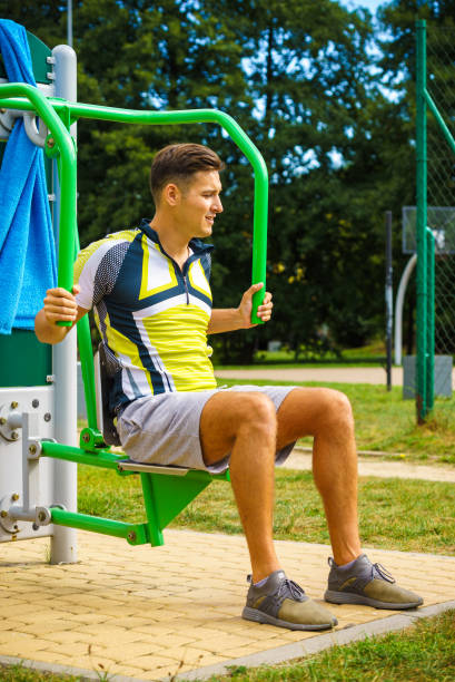 istock Man flexing arm in outdoor gym 1177170812