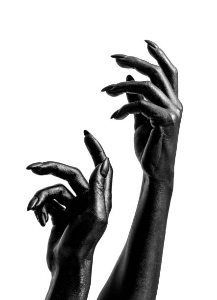 Bare-footed black ethnic woman showing her yellow-painted nails and hands on the street