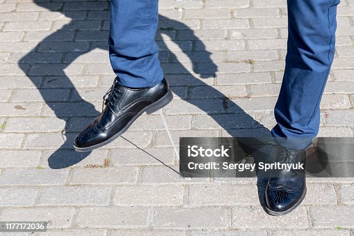 istock Foot stuck into chewing gum on street. Concept of stickiness 1177172036