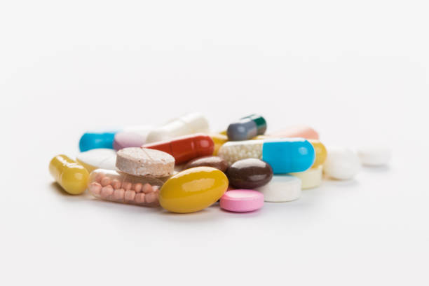 istock Assorted pharmaceutical medicine pills, tablets and capsules.Heap of assorted various medicine tablets and pills different colors on white background. 1177173210