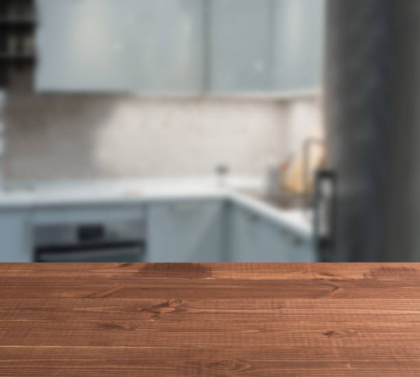 wooden table top and blur kitchen room of the background - domestic kitchen kitchen sink contemporary counter top imagens e fotografias de stock