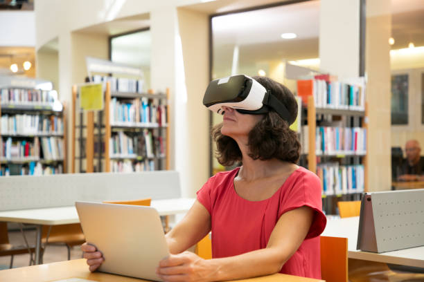 istock Adult female student watching VR presentation in library 1177174606