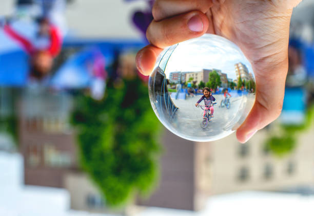 istock Child playing in park  through the lensball 1177174868
