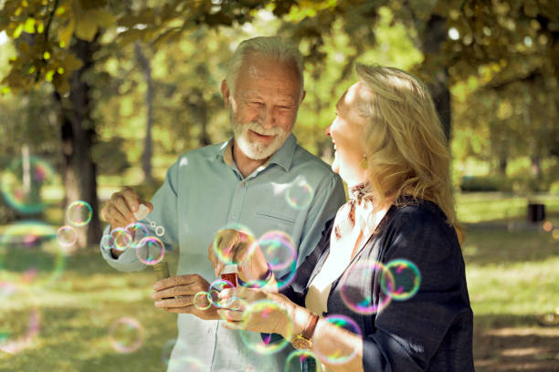 istock Silly senior couple blowing bubbles 1177178591