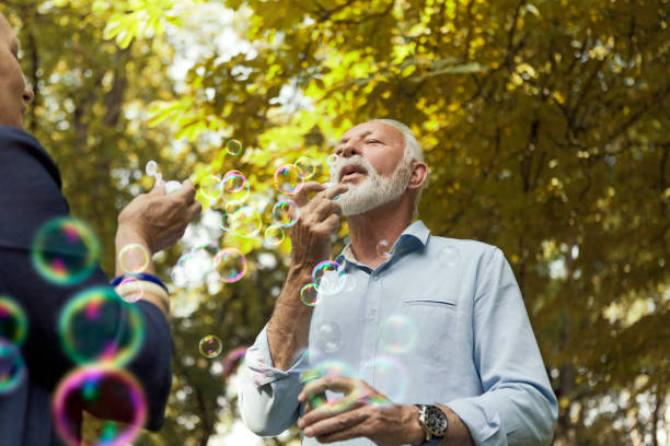 istock Senior couple enjoying themselves blowing bubbles 1177178800