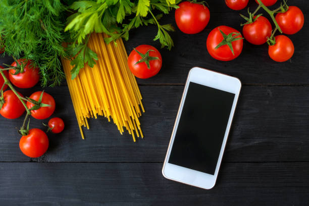 istock Pasta and cherry tomatoes on a wooden table. 1177180702