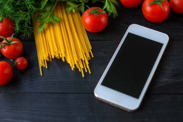 istock Pasta and cherry tomatoes on a wooden table. 1177180712