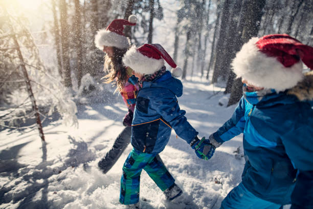 istock Kids enjoying winter forest on Christmas 1177182128
