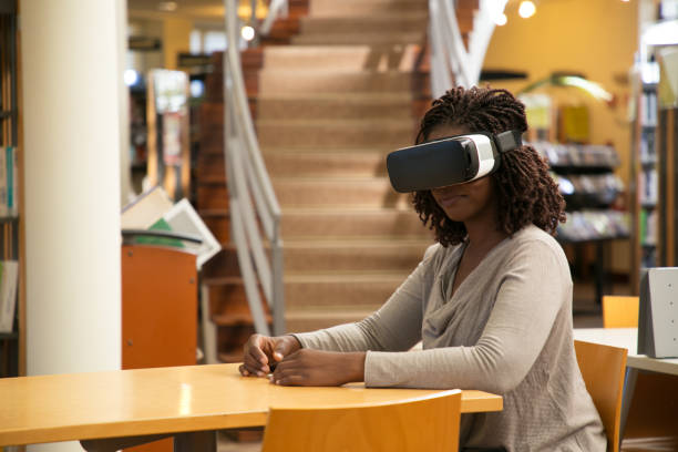istock Happy female student enjoying VR experience in library 1177182559