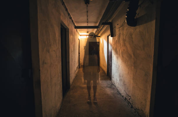 Little girl ghost horror movie Scary girl in night gown in a dark basement hallway. cosplay event stock pictures, royalty-free photos & images