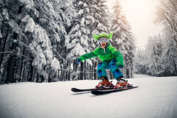 istock Little boy skiing fast on a beautiful winter day 1177188697