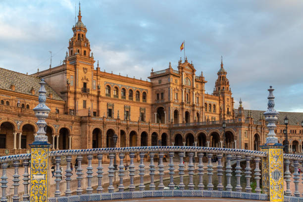 the plaza de españa is a plaza in the parque de maría luisa, in seville, spain. - seville sevilla bridge arch fotografías e imágenes de stock