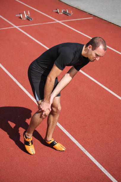 istock Athlete with pain in his knee on running track 1177190725