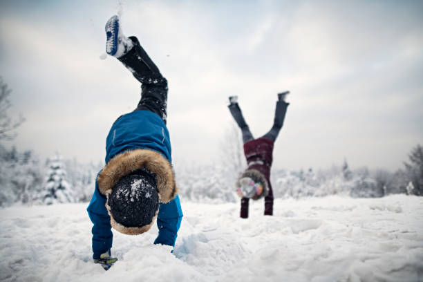 Mother with children running and playing in nature in the winter forest