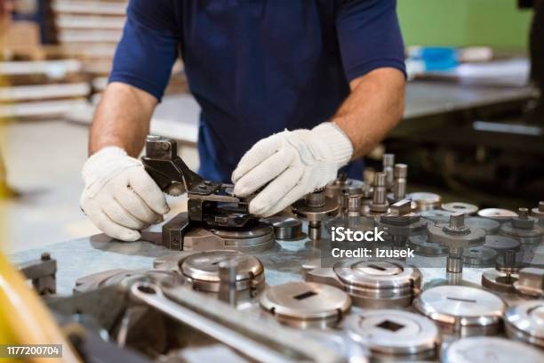 Male Apprentice Using Manufacturing Machinery Stock Photo - Download Image Now - Manufacturing Occupation, 20-24 Years, Adult