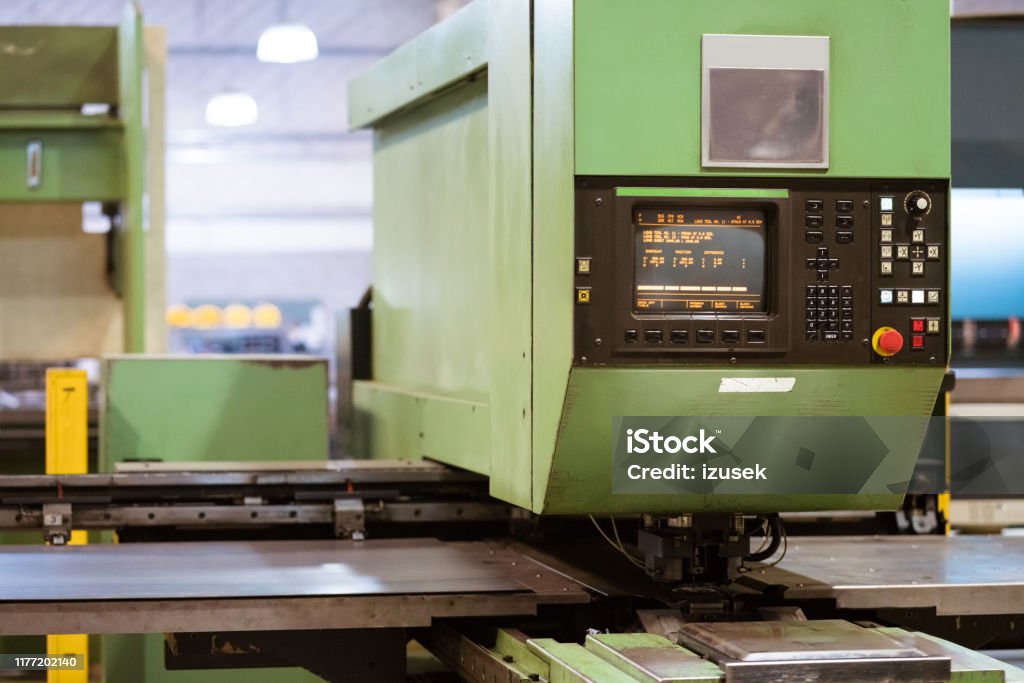 Puller machine in metal industry Green puller machine in industry. Control panel on manufacturing machinery. It is in factory. Absence Stock Photo