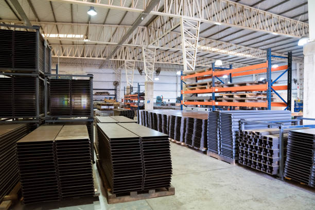 Stack of metallic sheets on rack. Machine parts arranged in industry.