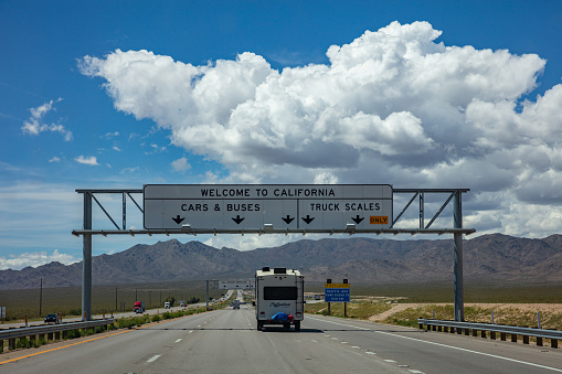 California highway, USA. May 29, 2019: Welcome to California road sign billboard on the highway, blue cloudy sky