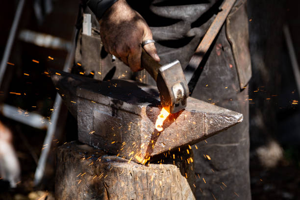 istock The blacksmith manually forging the molten metal on the anvil in smithy with spark fireworks 1177202424