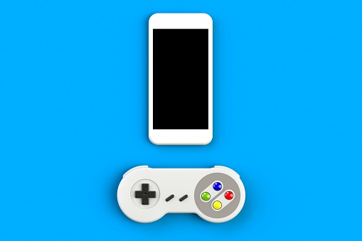 Video game console GamePad. Gaming concept. Top view retro joystick with smartphone isolated on blue background, 3D rendering