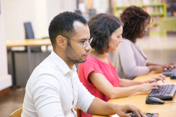 istock Serious adult male student studying in computer class 1177203798