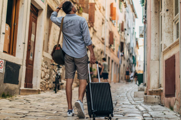 istock Man tourist walking in old town 1177209826