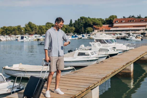 istock Tourist checking the time on pier 1177209926