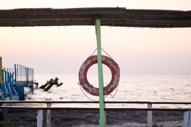 istock old lifebuoy on the pillar near a berth, sunset time 1177209994