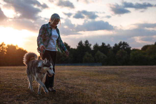 Senior woman walking with dog