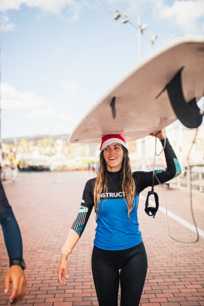 istock An attractive instructor blonde girl walking with her surfboard 1177211443