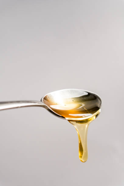 istock drip of honey falling from a spoon 1177213728