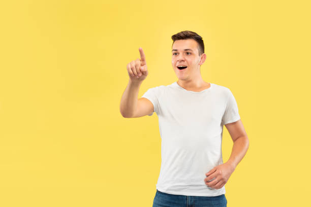 istock Caucasian young man's half-length portrait on yellow background 1177215962