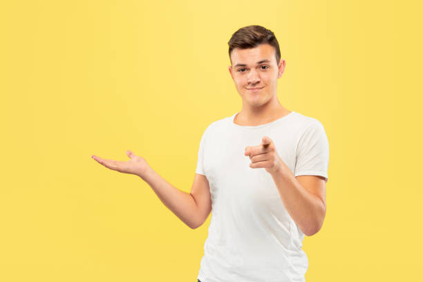 istock Caucasian young man's half-length portrait on yellow background 1177216016