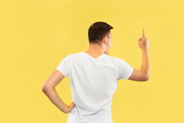 istock Caucasian young man's half-length portrait on yellow background 1177216192