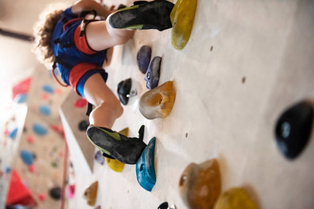 Colored hand/foot holds on a rock climbing wall.