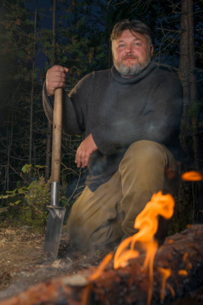 istock Man in the evening by the fire. 1177216487
