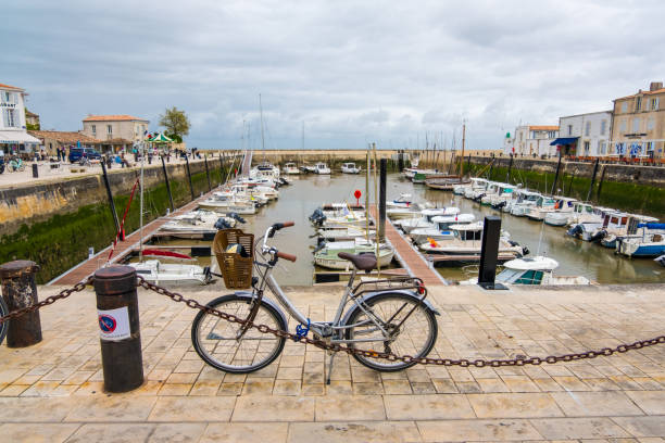 Harbour and quayside at La Flotte on Ile de Re island. It is one of the most beautiful villages in France St Martin De Re, France - May 09, 2019: Harbour and quayside at La Flotte on Ile de Re island. It is one of the most beautiful villages in France flotte stock pictures, royalty-free photos & images