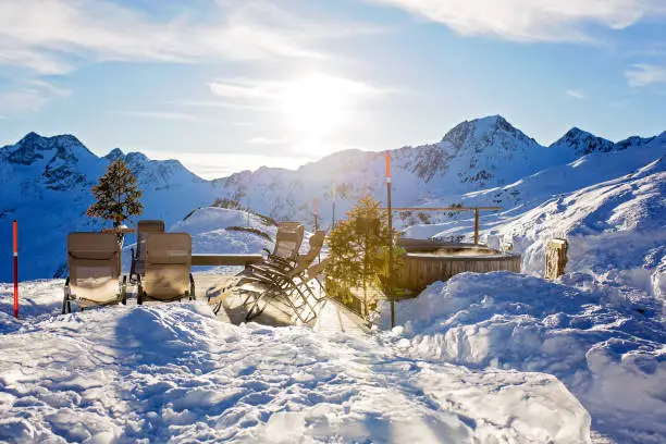 Photo of Sunny day in Tyrol mountains. People having fun skiing