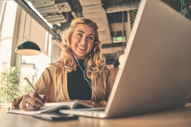 istock Happy young caucasian business woman entrepreneur using computer looking at screen working in internet sit at office desk, smiling female professional employee typing email on laptop at cafe. 1177223169