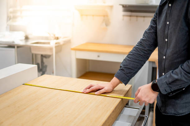 istock Asian man using tape measure on countertop 1177223219