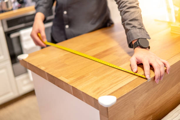 istock Asian man using tape measure on countertop 1177223251