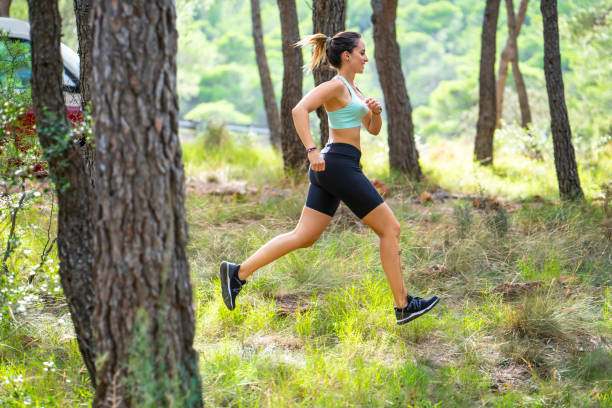 istock Young woman running in forest 1177226419