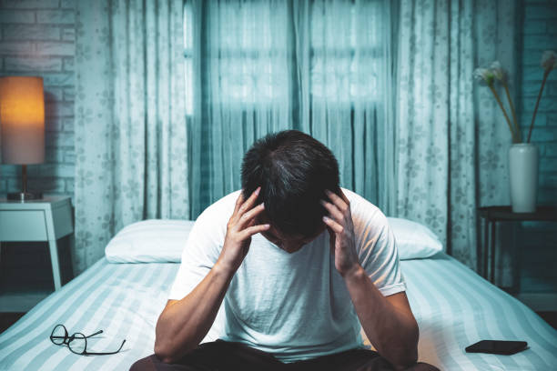 istock asian man sitting on bed suffering insomnia and sleep disorder thinking about his problem at night 1177227630